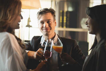People young man and woman smiling and laughing happy Clink a glass of champagne and wine to celebrate at a party in the bar restaurant