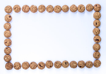 Frame of Dutch gingerbread cookies (pepernoten, kruidnoten), special traditional candy for celebration of Sinterklaas in December, with white background
