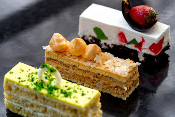 Set of tasty elegant desserts served on silver platter
