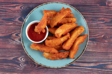 Potatos wedges with tomato sauce served in dish isolated on background side view of fastfood