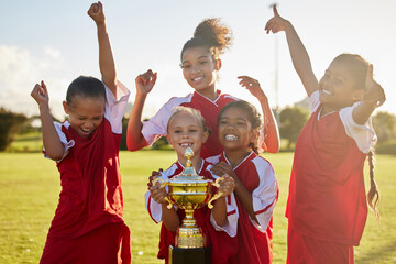 Children, football trophy and winning team of sports competition on soccer field for celebration of goal, win and teamwork after a match outdoors. Youth, kids or girls club after a tournament game