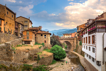 Medieval village of Cangas de Onis with hanging houses and Sella river, Asturia, Spain. - obrazy, fototapety, plakaty