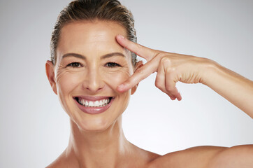 Skincare, beauty and face of mature woman with anti aging product to reduce lines and wrinkles...