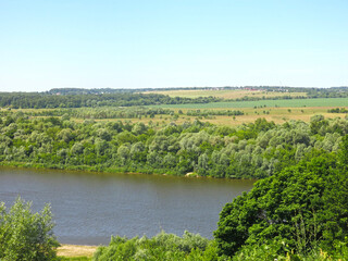 summer panorama of the Oka River with hills, fields and trees along the banks