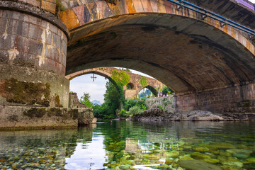 Fototapeta premium Medieval village of Cangas de Onis with hanging houses and Sella river, Asturia, Spain.
