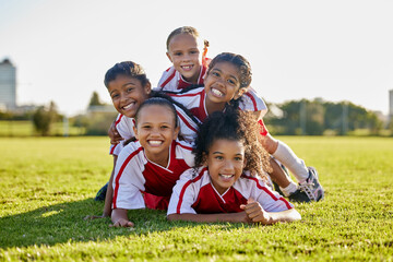 Naklejka na ściany i meble Soccer, training and children on sports field for football game, exercise or cardio together. Portrait of girl kids, athlete group and players with smile and partnership, teamwork and sport at school