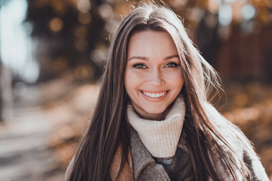 Photo of optimistic long brown hairdo lady wear coat scarf outdoors at the street