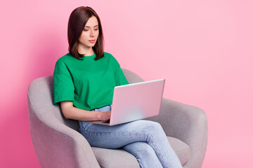 Photo of focused concentrated person use wireless netbook write email isolated on pink color background