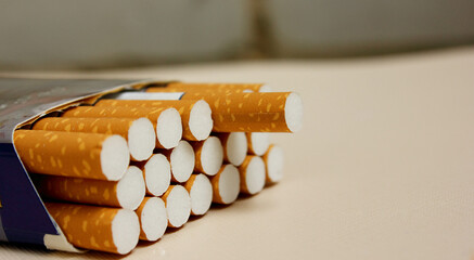 A pack of cigarettes on a white background. open pack of cigarettes. Yellow filter. Harm to health. It is a bad habit. The concept of World No Tobacco, Tobacco and Lung Health. Cigarettes in a tutu.
