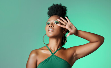 Beauty, fashion and empowerment with a beautiful black woman in studio of a green background for...