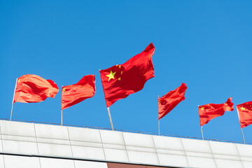 Chinese national flags waving on rooftop