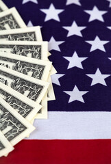 US dollar bills on a flag. Inflation, finance or money savings vertical background.