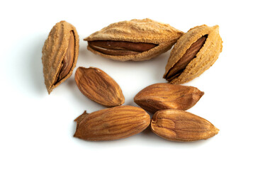 A bunch of selected dried inshell almonds isolated on white background. Selective focus.