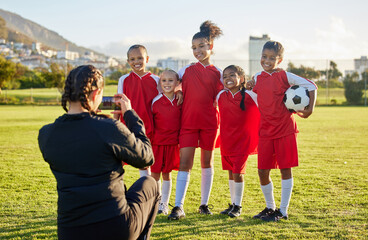 Soccer, photograph and sports coach with a girl team posing for a picture outdoor on a football...