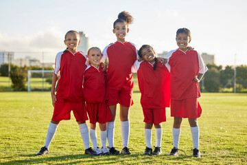 Girl team, kids on soccer field and sports development for happy girls in group portrait together....