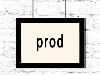 Black frame hanging on white brick wall with inscription prod