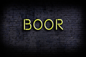 Neon sign. Word boor against brick wall. Night view