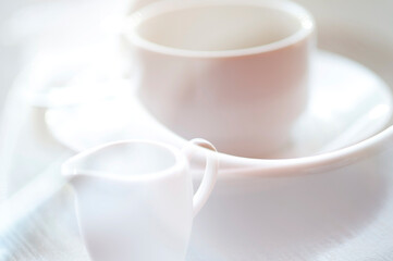 Defocused view of white cup of hot coffee
