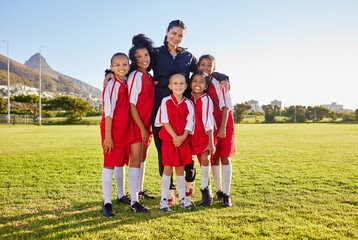 Team, soccer and coach smile on field together in portrait after training, game or workout in sun....