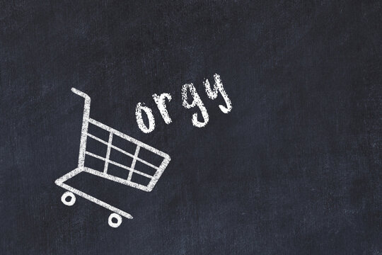 Chalk drawing of shopping cart and word orgy on black chalboard. Concept of globalization and mass consuming