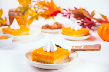 Slice of fresh baked traditional american homemade pumpkin pie decorating whipped cream for celebrating holidays