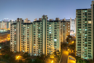 BUCHEON, SOUTH KOREA: aerial view of typical apartment buidings (called Danji in Korean) at night with illuminated individual appartments