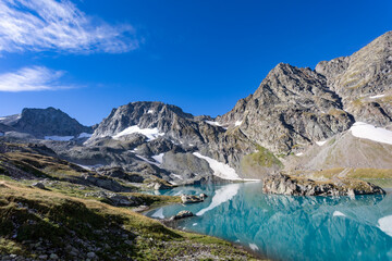 Fototapeta na wymiar View of a blue mountain lake in the Caucasus Russia against the background of impressive steep mountain peaks