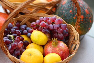 Hokkaido pumpkins and vintage baskets filled with various autumnal produce in the garden. Selective focus.