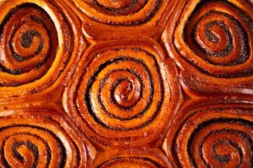 Freshly baked sweet cinnamon bun roll swirl pattern background