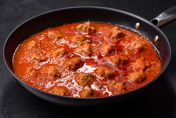 Delicious meatballs made from ground beef in a spicy tomato sauce