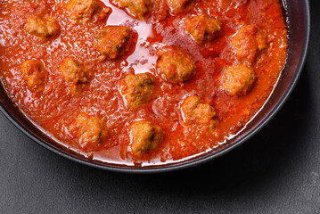 Delicious meatballs made from ground beef in a spicy tomato sauce