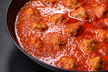 Delicious meatballs made from ground beef in a spicy tomato sauce