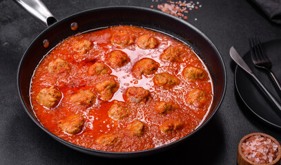 Delicious meatballs made from ground beef in a spicy tomato sauce