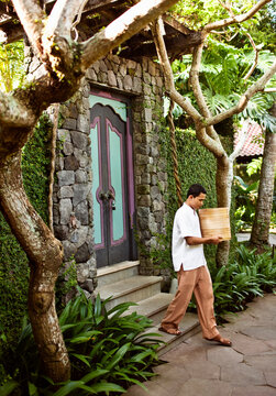 A butler leaving a private pool villa a hotel in Ubud, Bali, Indonesia.