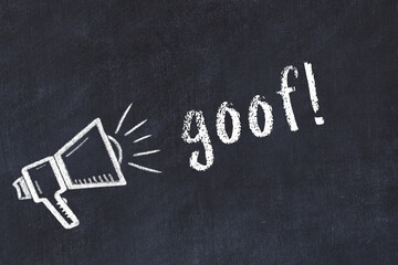 Chalk loudspeaker and inscription goof on black chalkboard