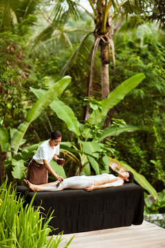 Woman receiving mud body masque at a spa in Ubud, Bali, Indonesia.