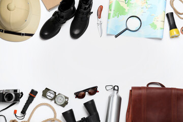 Flat lay composition with different safari accessories on white background, space for text
