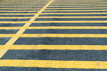 Fototapeta na wymiar Yellow speed bump on asphalt road