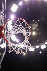 Shallow depth of field (selective focus) details with a basketball panel and net before an official...