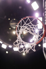Shallow depth of field (selective focus) details with a basketball panel and net before an official...