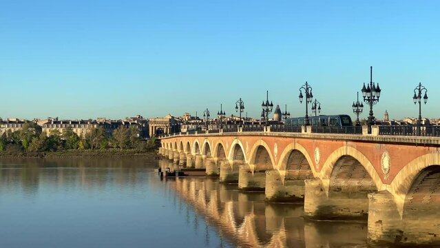 Garonne river, Pont de Pierre bridge and spire of Saint-Michel basilica on a summer day