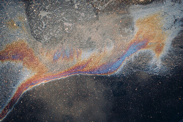 Spilled gasoline rainbow background, Industrial hazard spill pollution
