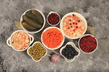 Fermented products on a concrete table, food background, advertising banner, healthy food concept, sauerkraut, kimchi, pickled beets, cucumbers, peas, olives, 