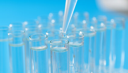 Liquid drop to test tube on blue background