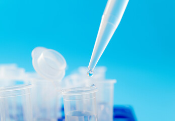 Liquid drop to test tube on blue background