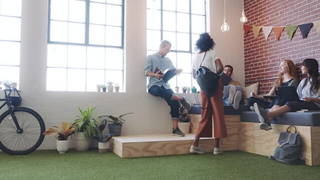 Creative startup meeting, people with project business proposal for teamwork, collaboration and strategy brainstorming in a relax workspace. Design students, gen z group with documents planning idea