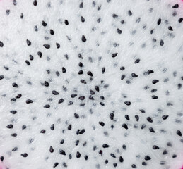 Fresh pulp dragon (pitaya or pitahaya) fruit textured background, white surface sweet with black...