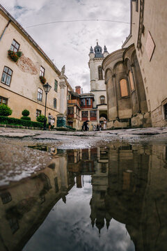 24.09.2022 Ukraine. Lviv. 4.10.2022 Walk through the historic center of the old city of Lviv. Reflection of the city in puddles.