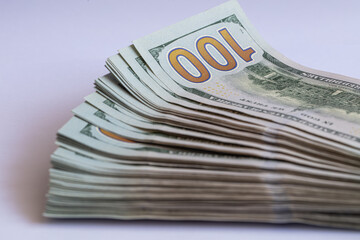 Pile of 100 dollar banknotes on white background