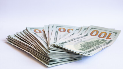Pile of 100 dollar banknotes on white background